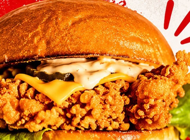 Crispy fried chicken burger with cheese, pickles and sauce